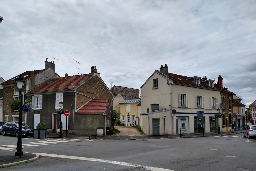 a street corner with a few buildings and cars parked on the side of the road