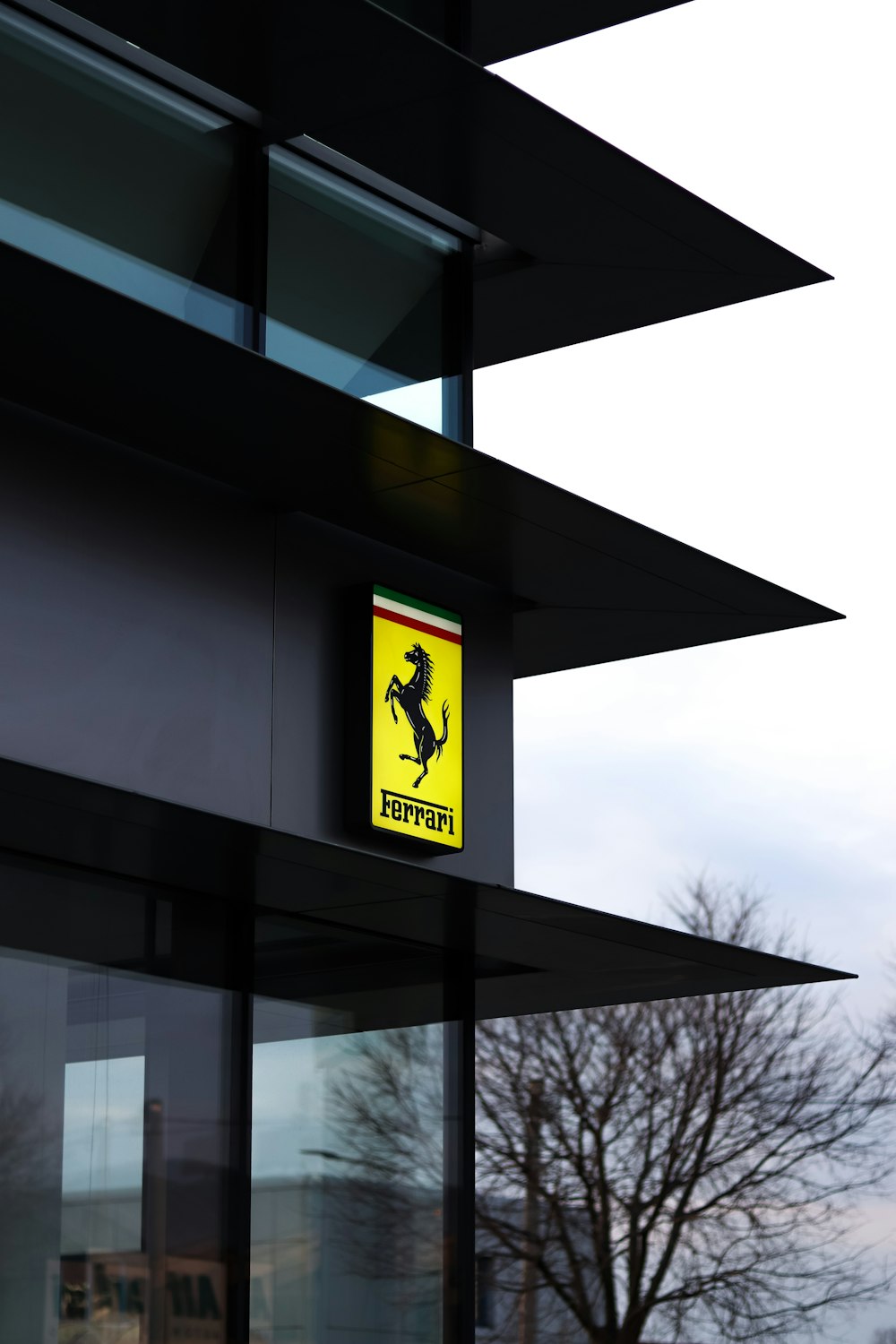 a yellow and black sign on the side of a building