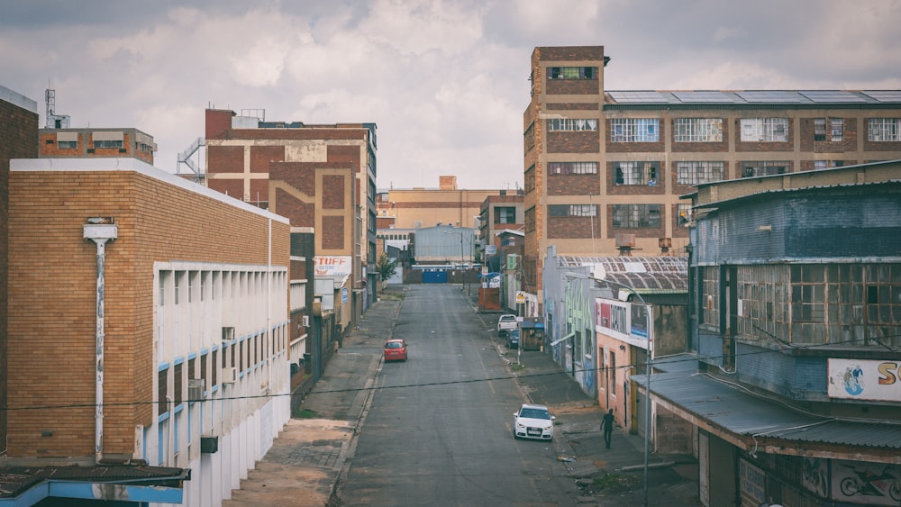 a city street lined with tall brick buildings