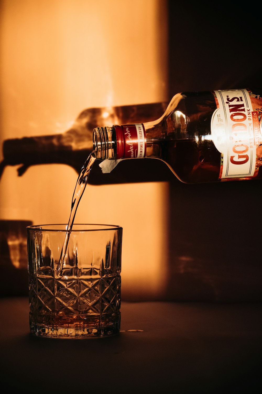 a bottle of beer being poured into a glass