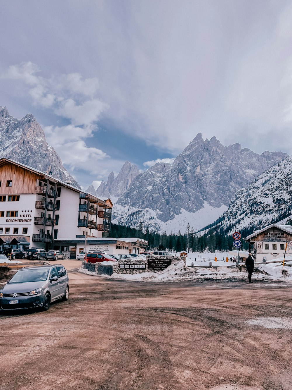 a couple of cars parked in front of a building