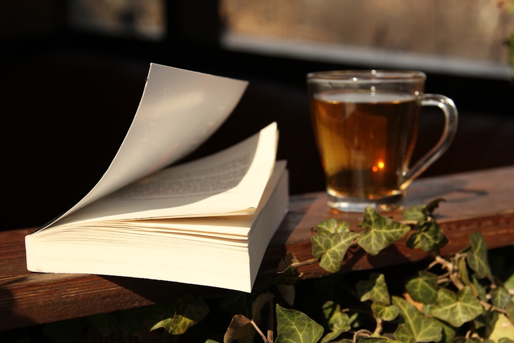 a cup of tea and a book on a table