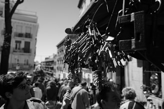 Portrait of Nilesh Damodar Prabhu holding a key symbol, standing in a lively neighborhood with children playing nearby.