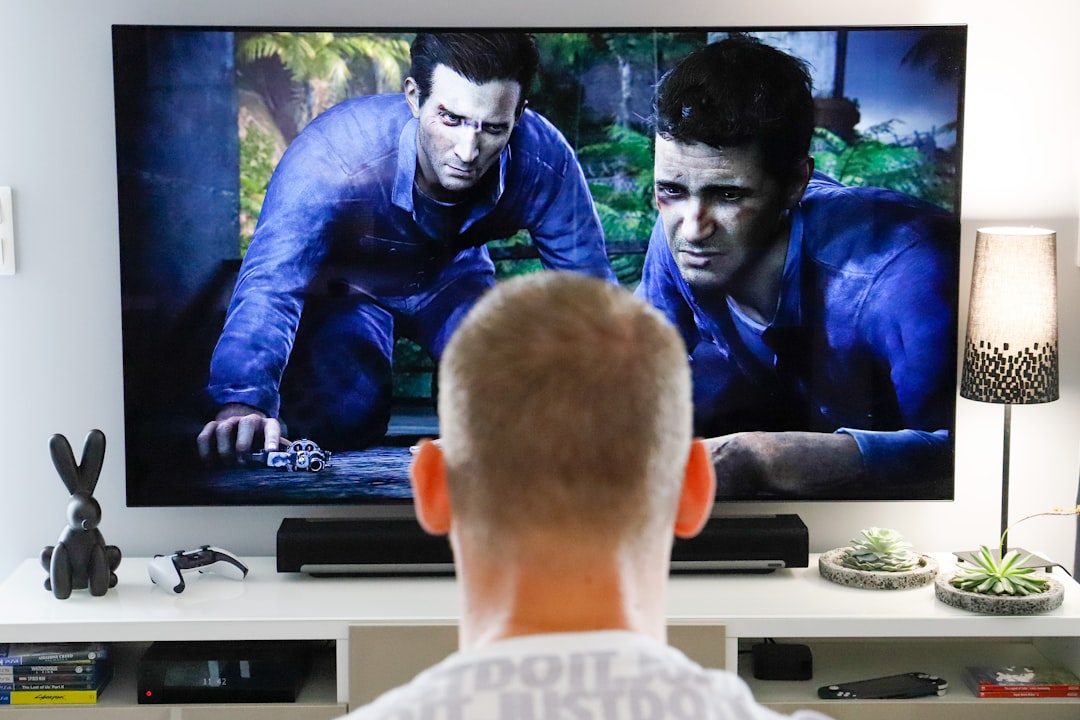 a man watching a movie on tv in his living room,