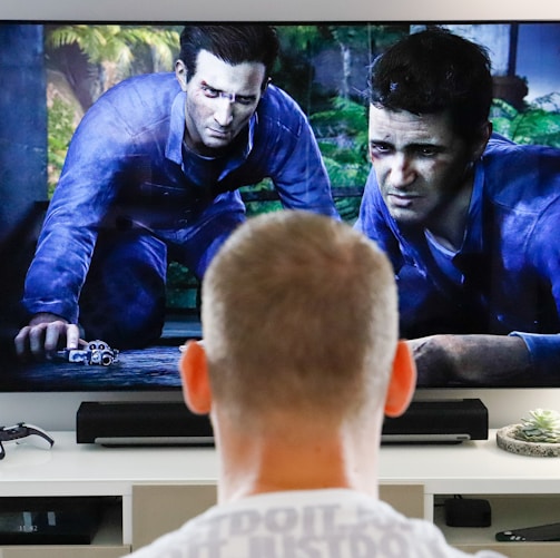 a man watching a movie on tv in his living room