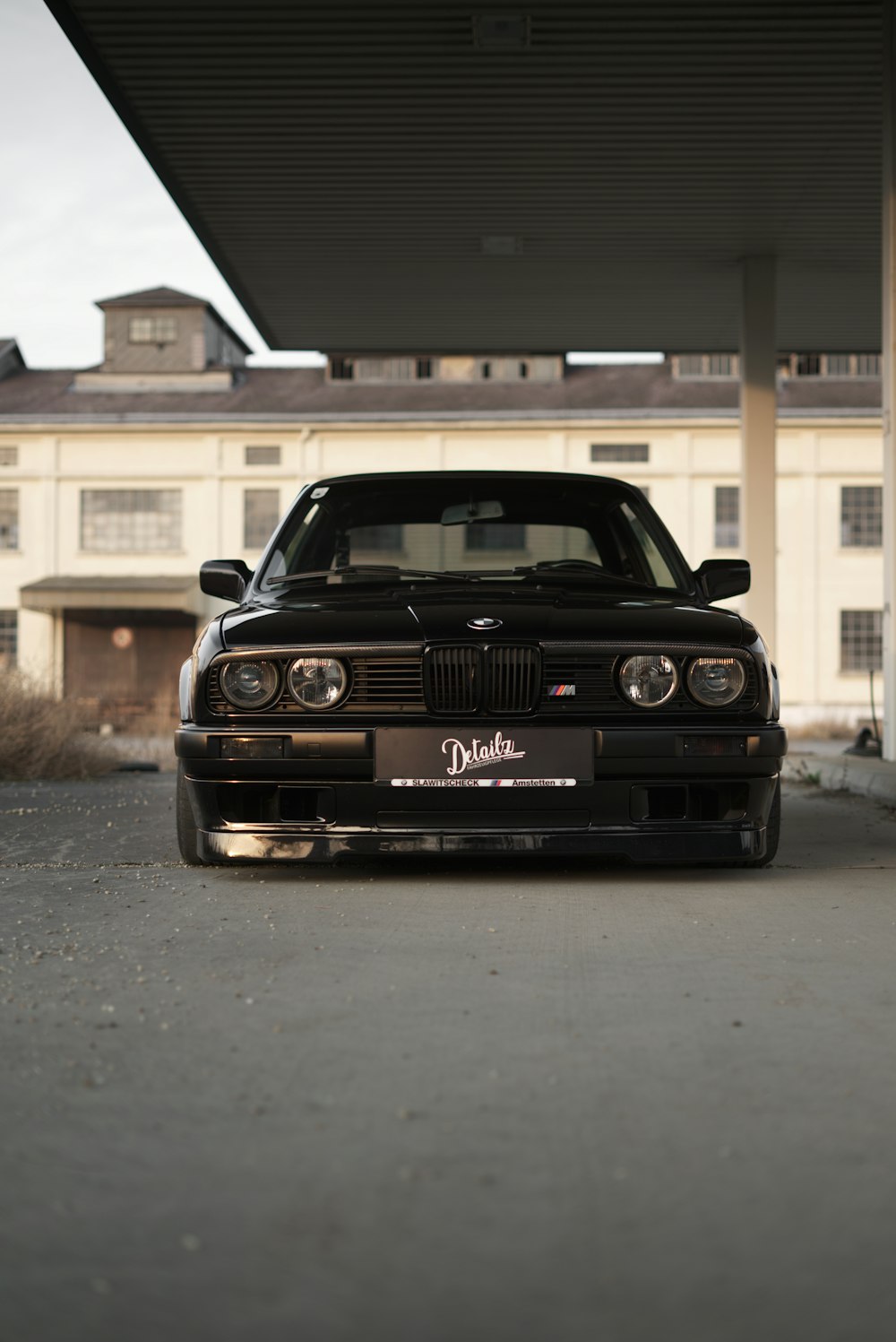 a black car parked in front of a building