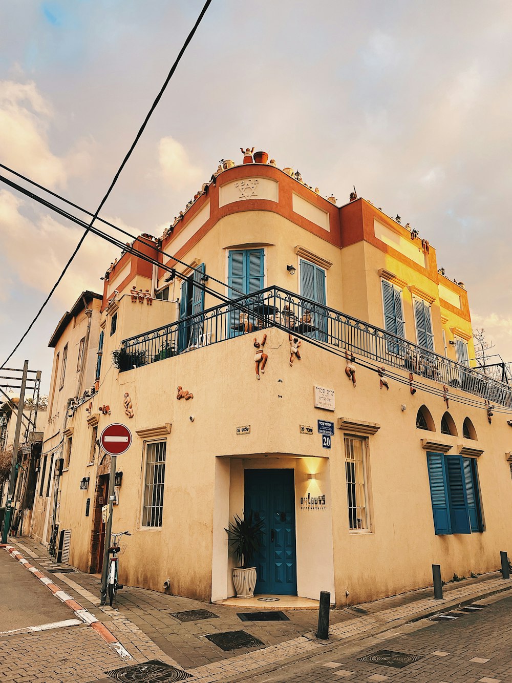 a yellow building with a blue door on a street corner