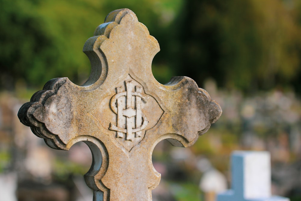 a close up of a cross on a grave