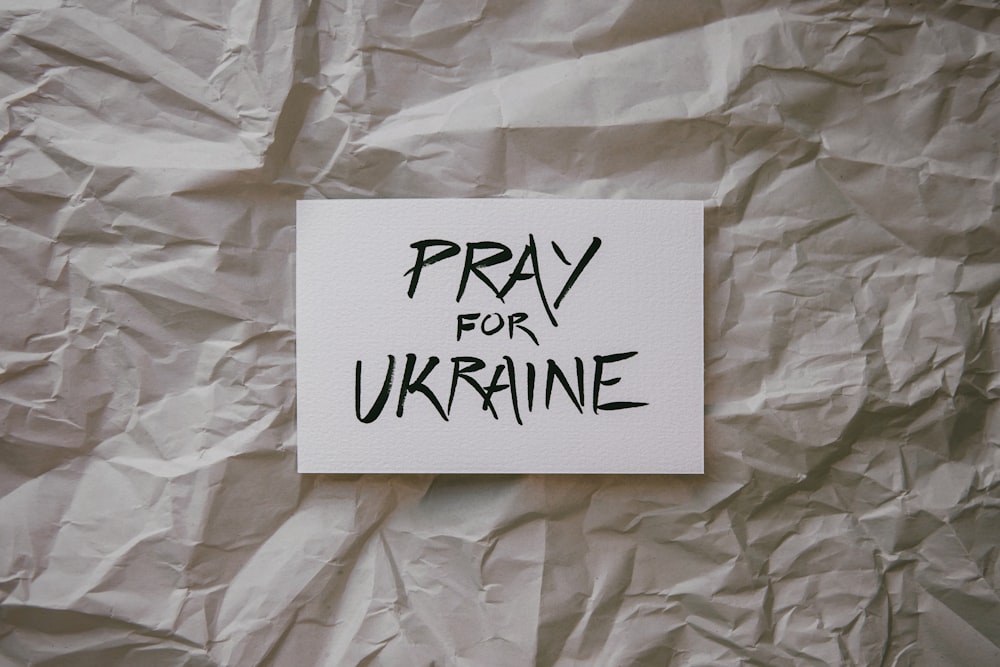 a piece of paper with the words pray for ukraine on it