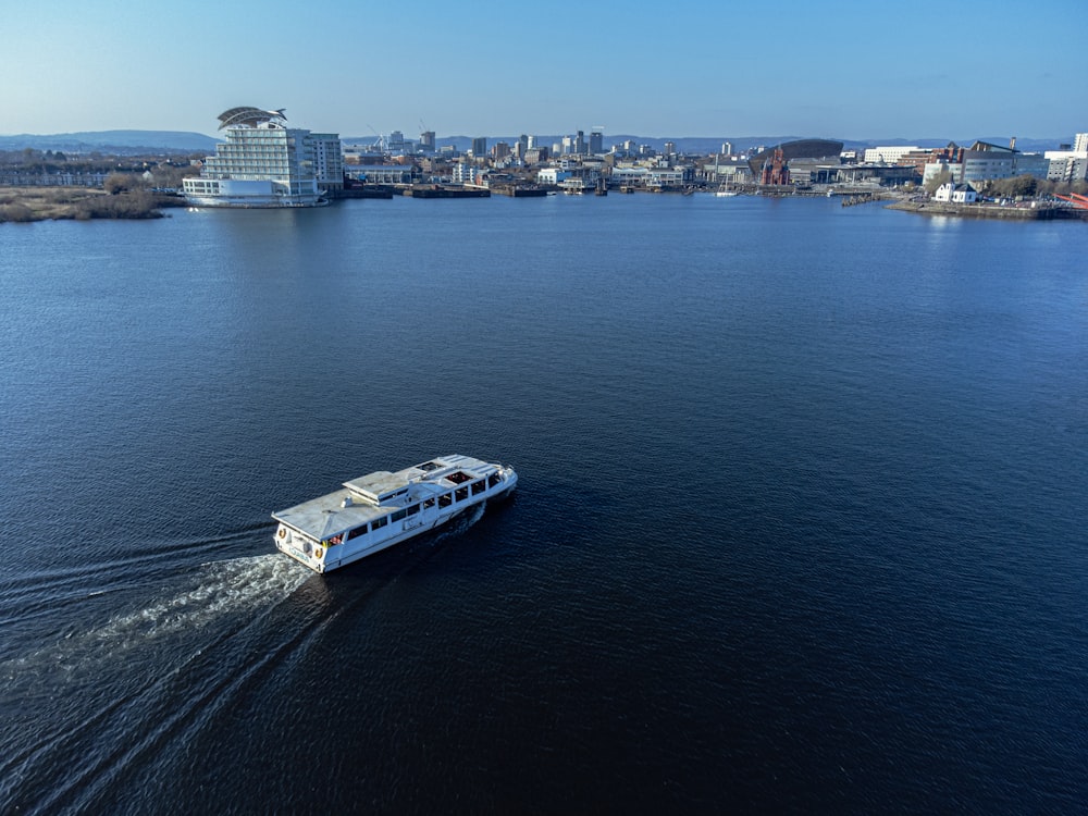 a white boat traveling across a large body of water