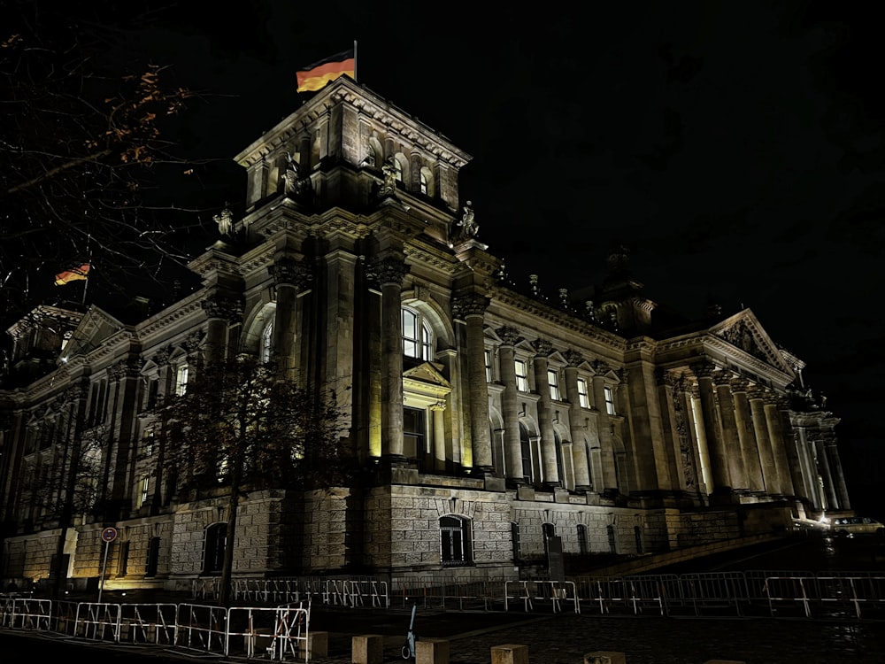 a large building with a clock tower at night