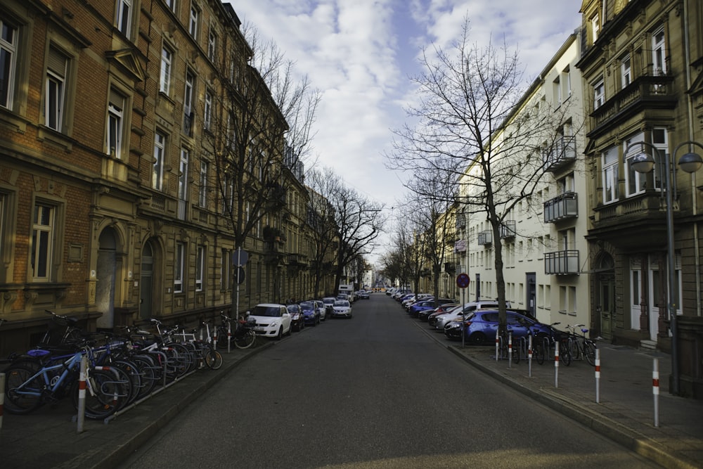 a street lined with parked bicycles and parked cars