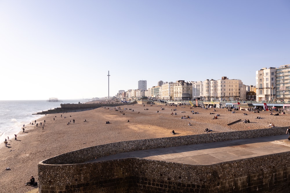 a group of people sitting on top of a sandy beach