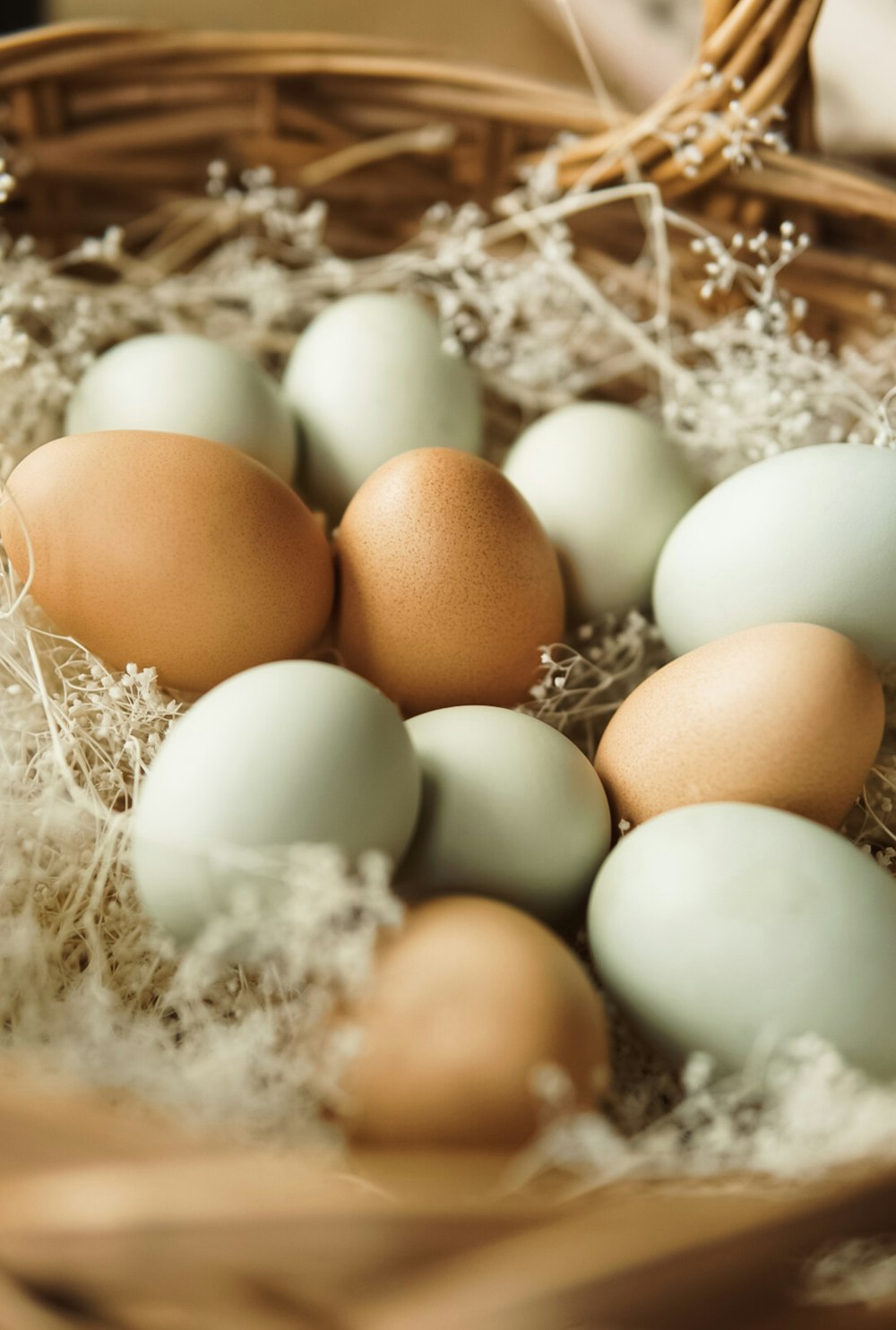 a basket filled with brown and white eggs