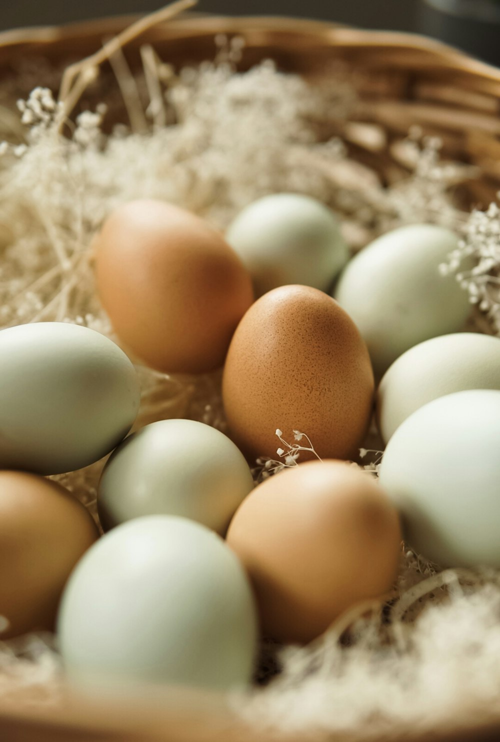 a basket filled with lots of brown and white eggs