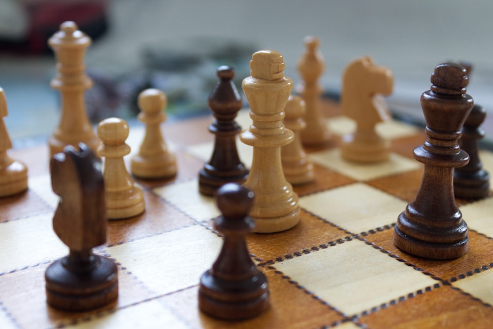 a close up of a chess board with pieces on it