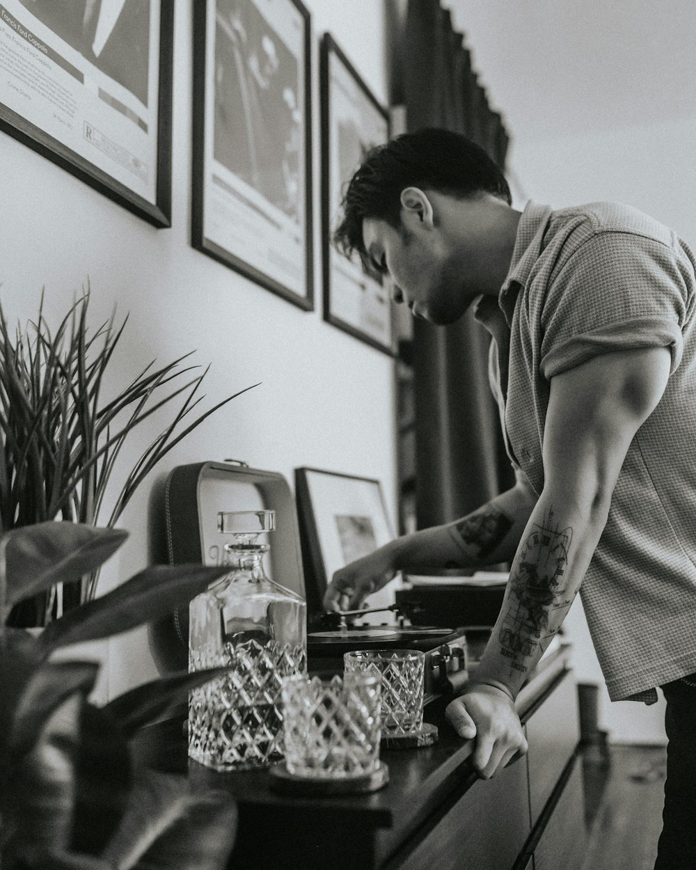 a man with a tattoo on his arm standing at a desk