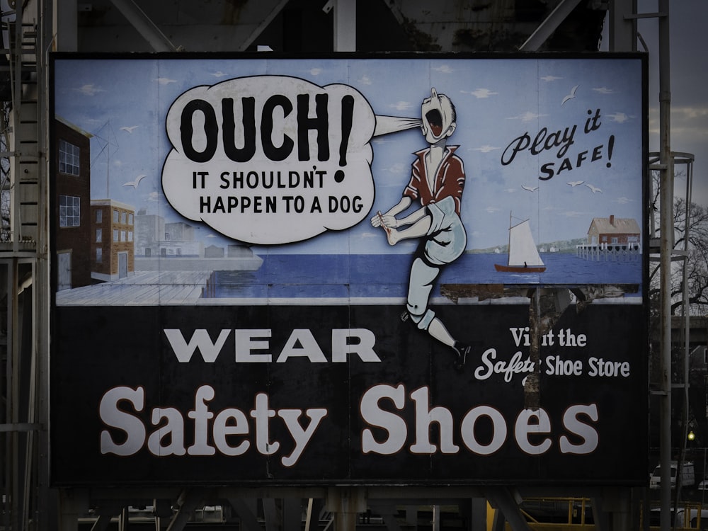 a sign advertising safety shoes on a city street