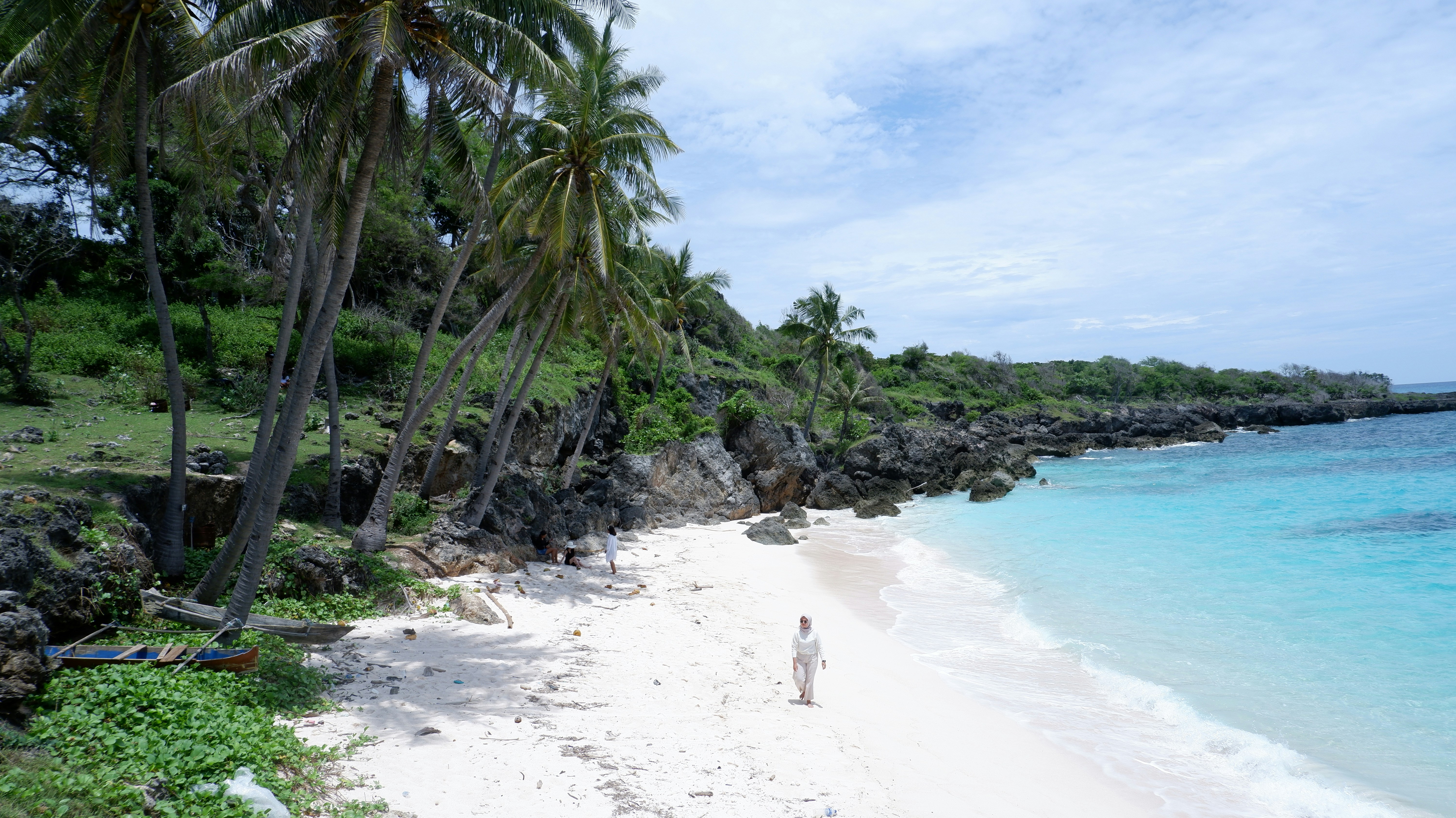 a person standing on a beach next to a body of water
