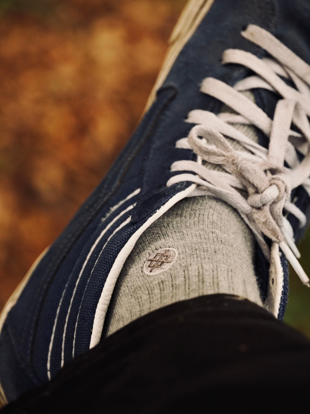 a close up of a person's shoes with white laces