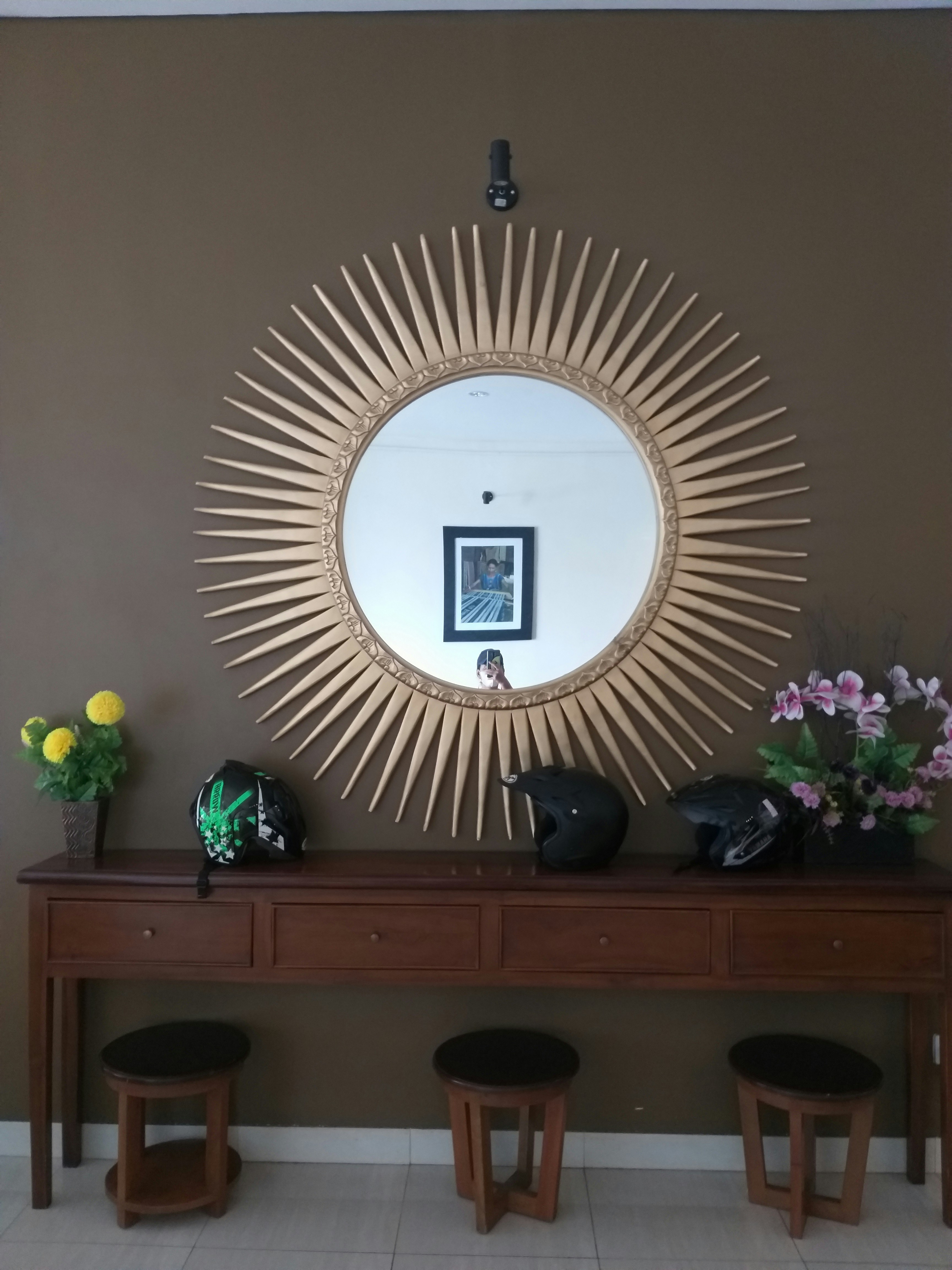round wicker mirror with natural light