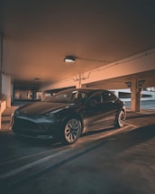 A clean, shiny car parked in a modern garage.