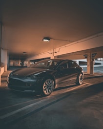 A clean, shiny car parked in a modern garage setting.