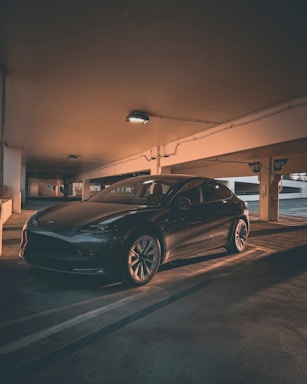 A clean, shiny car parked in a modern garage.