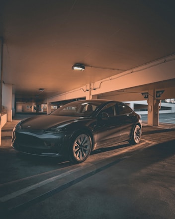 A clean, shiny car parked in a modern garage setting.