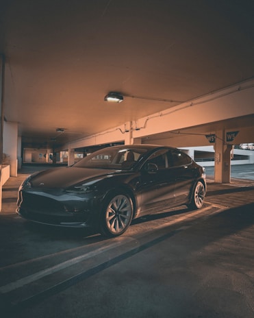 A clean and shiny car parked in a modern garage.