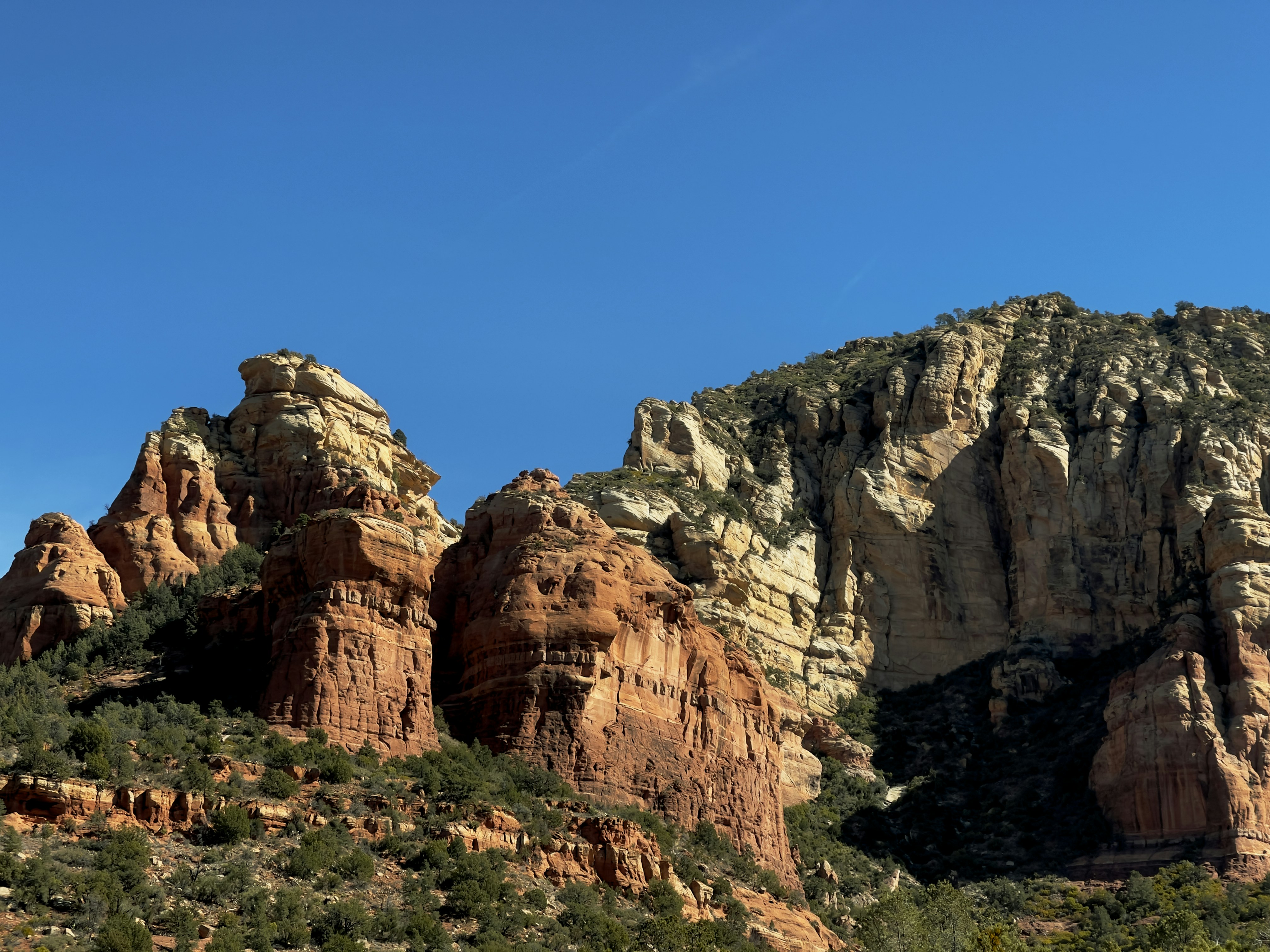 a group of mountains with trees on the side, 