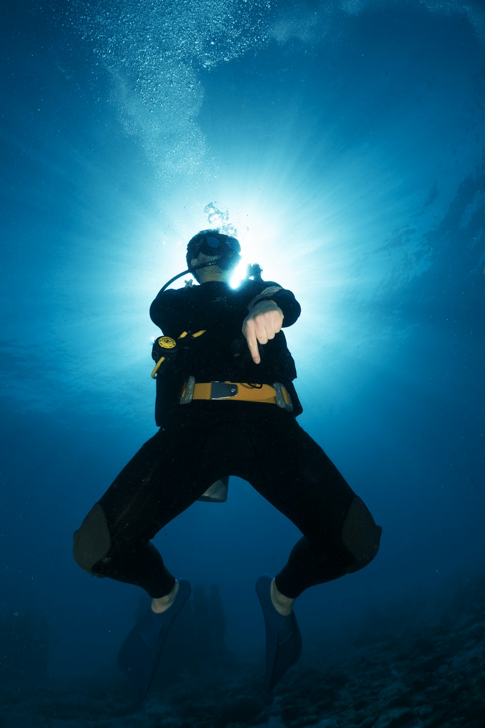 um homem em um traje de mergulho está debaixo d'água