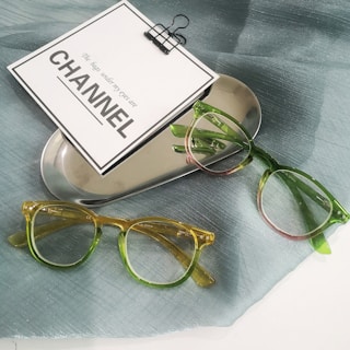 a pair of glasses sitting on top of a table