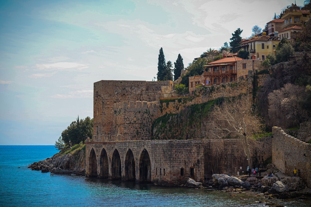 a castle on a cliff overlooking a body of water