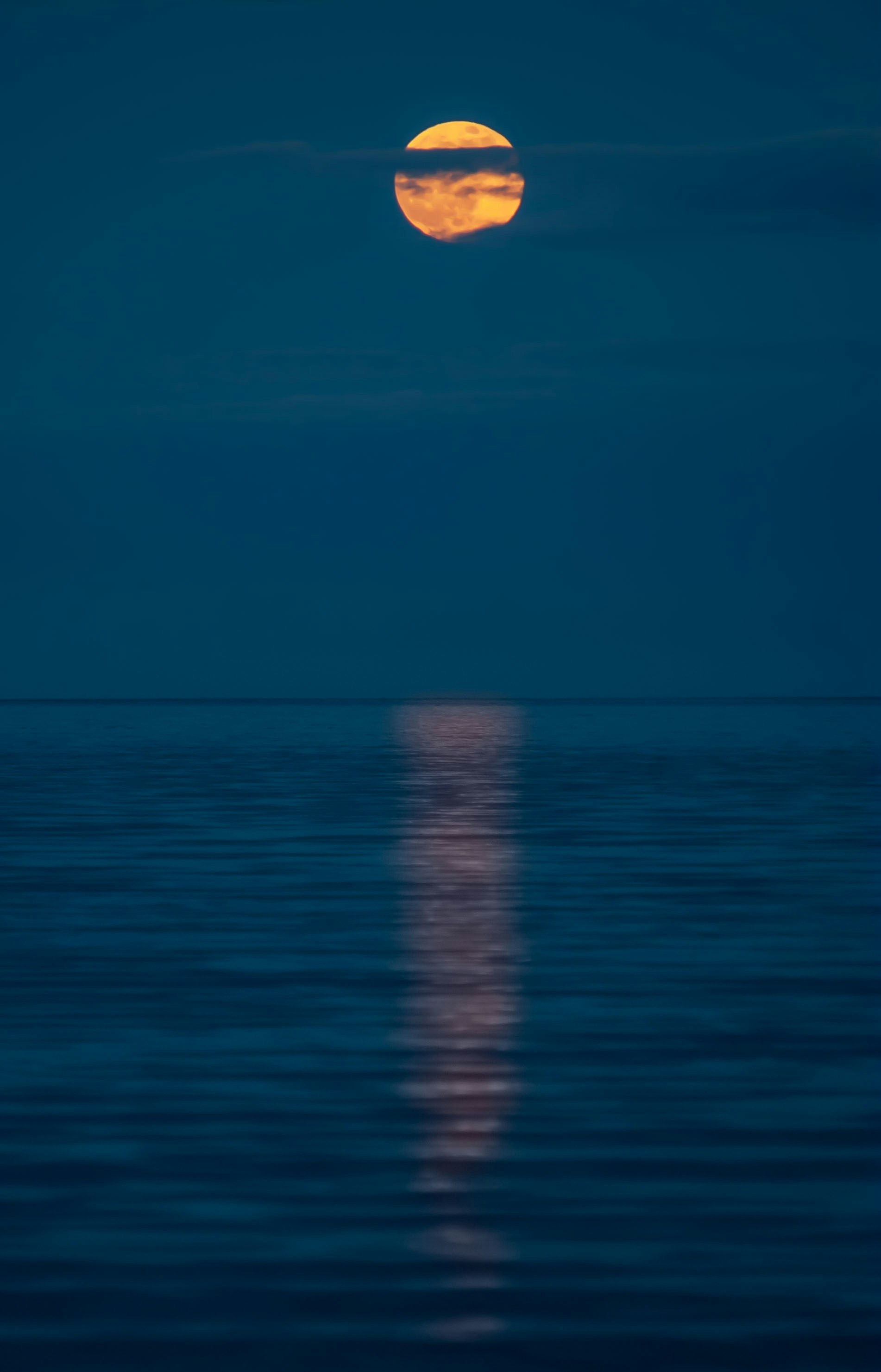 Calm ocean waves on a sandy beach.