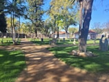 A peaceful view of a well-maintained cemetery plot under a clear blue sky.