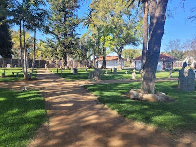 A peaceful view of a well-maintained cemetery plot under a clear blue sky.