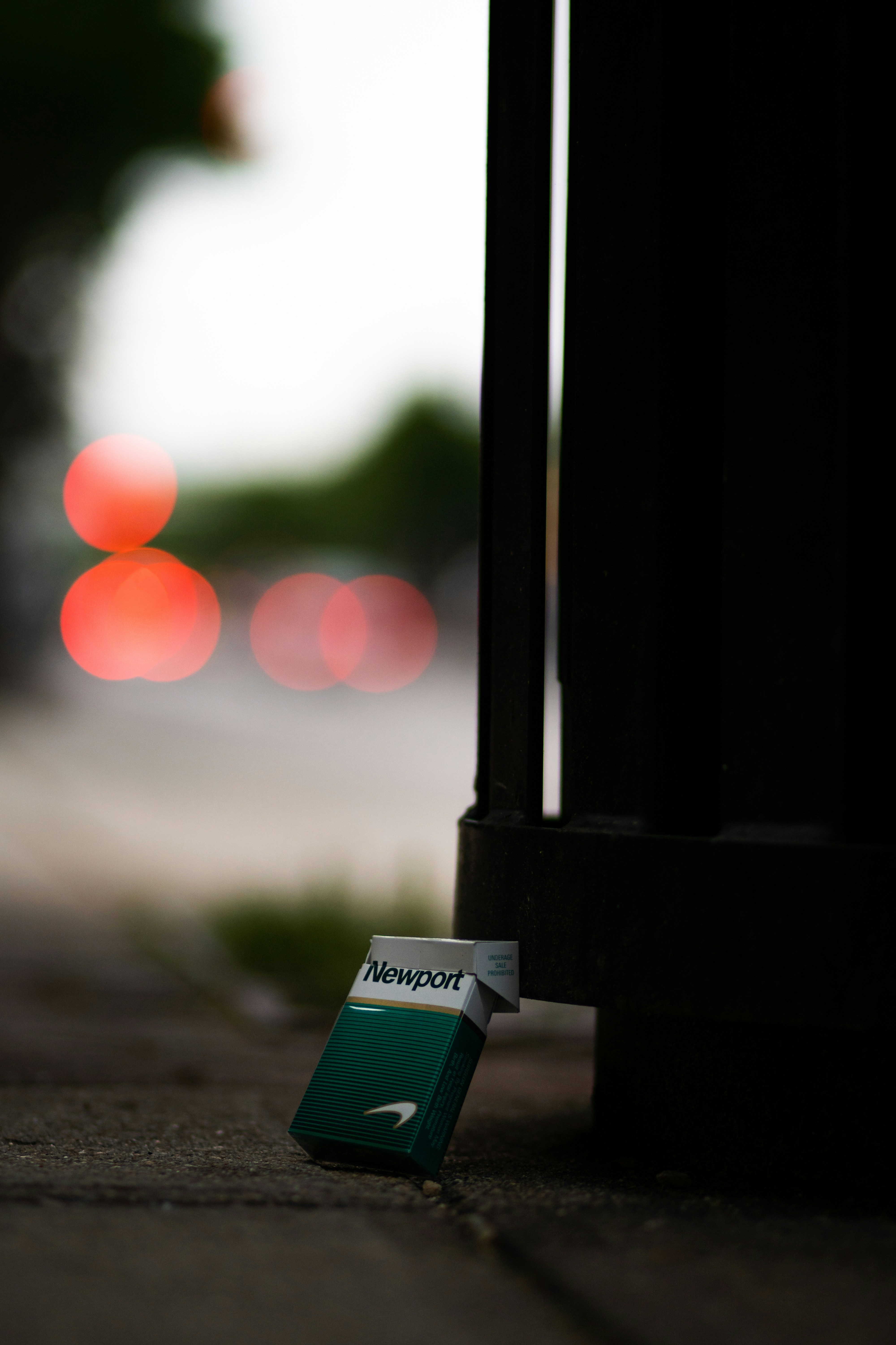 a close up of a street sign on the ground