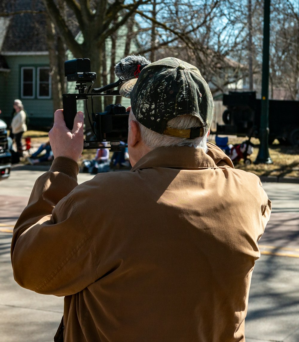 a man holding a camera up to take a picture