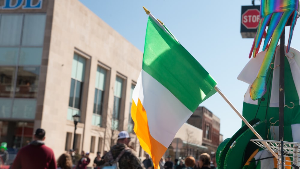 a group of people walking down a street holding flags