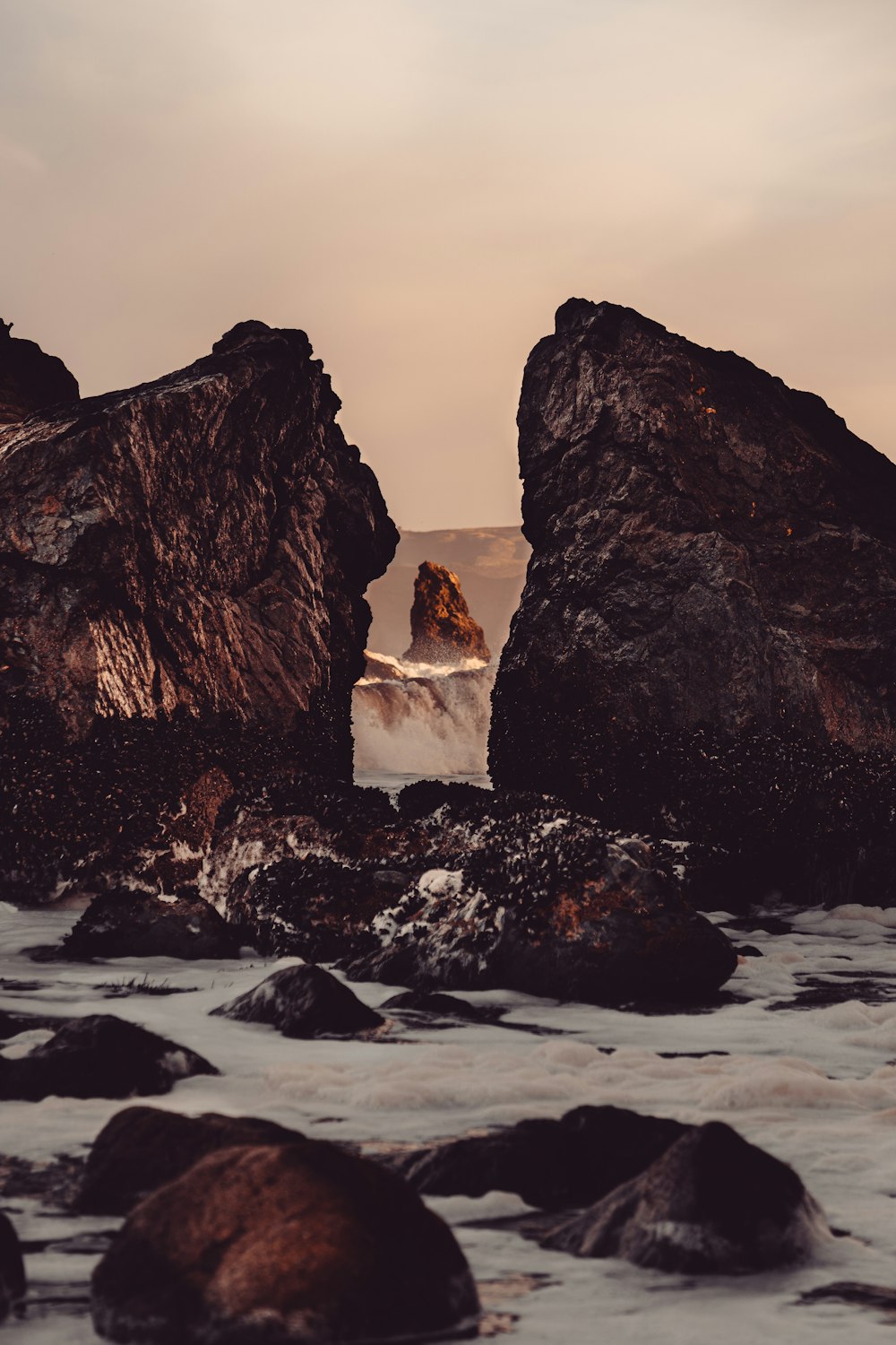 a couple of large rocks sitting on top of a beach