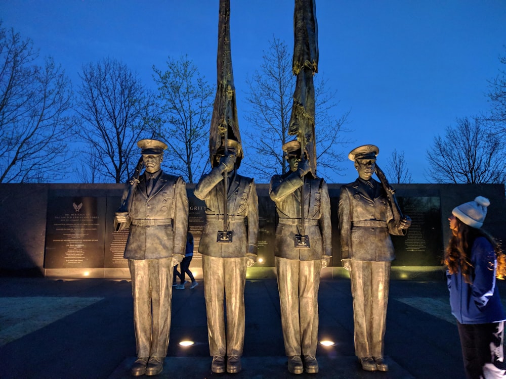 a group of people standing in front of a statue