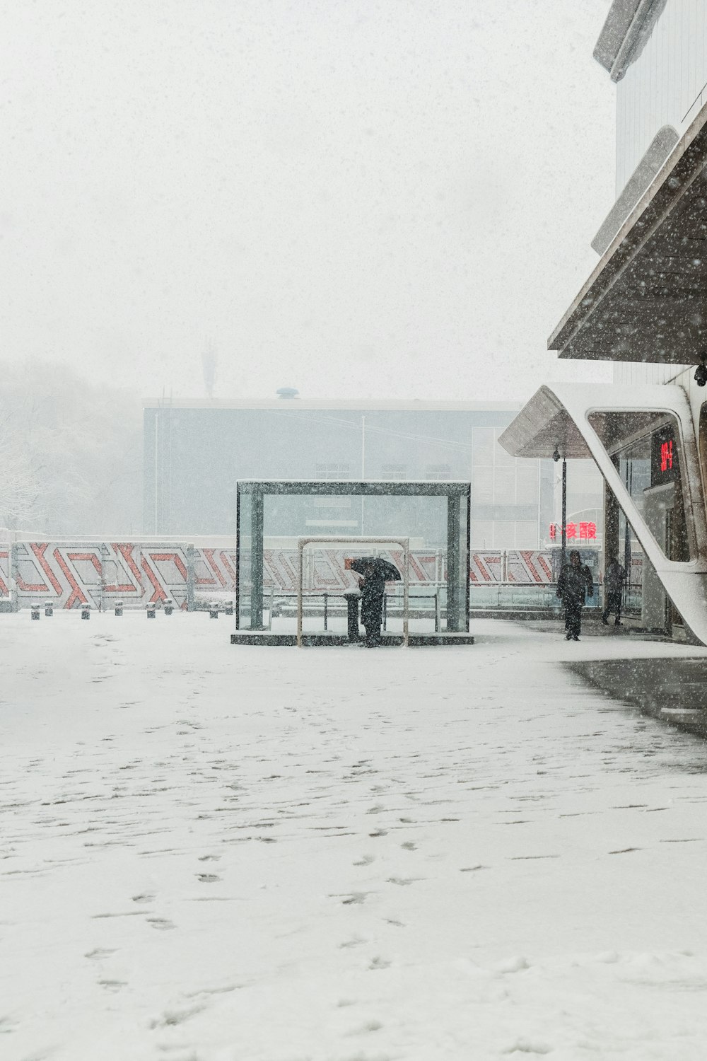 a couple of people that are standing in the snow