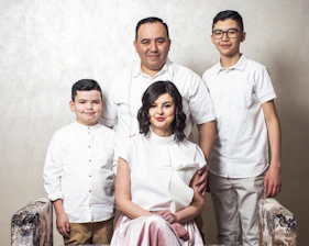 a family posing for a picture in front of a wall