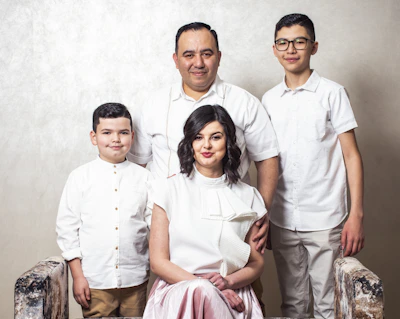 a family posing for a picture in front of a wall