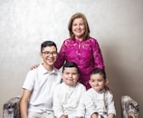 a woman and two boys are posing for a picture