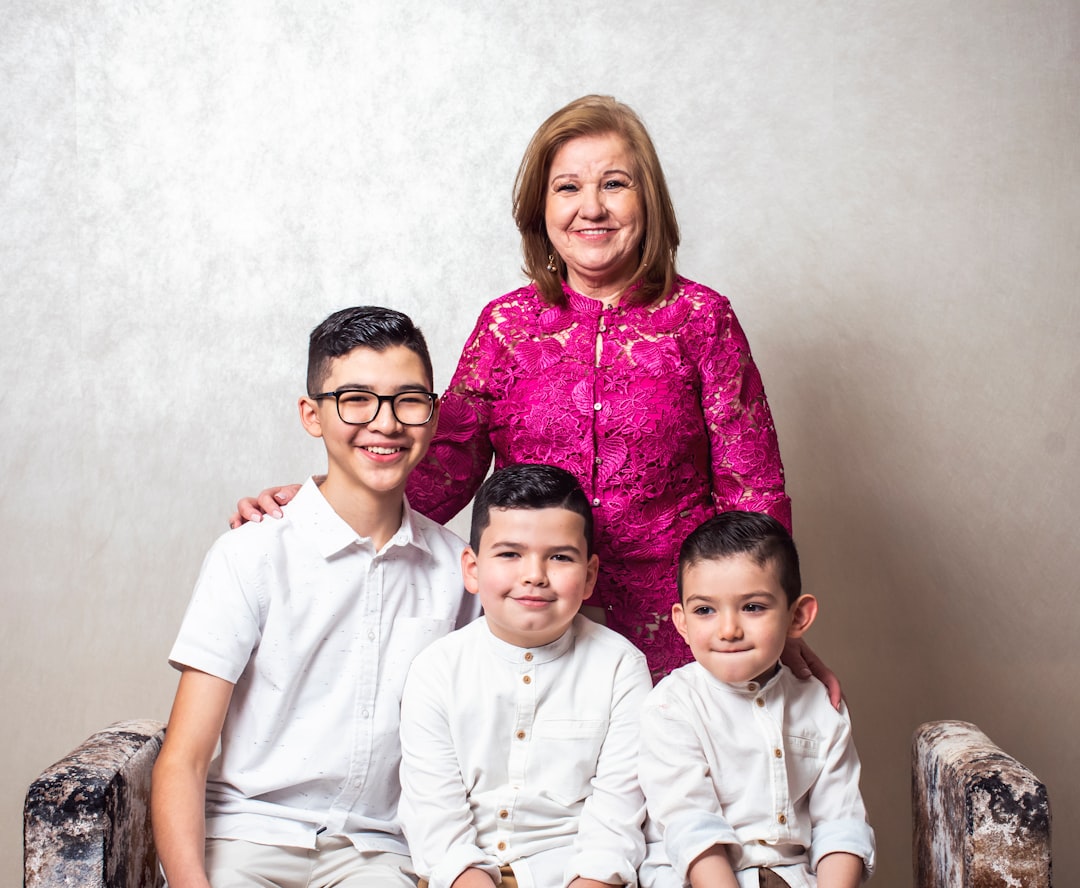 a woman and two boys are posing for a picture,