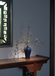 A delicate celadon vase with a soft, sky-blue glaze reflecting gentle morning light