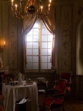 Elegant room set for a cultural evening, with candles and artful décor.