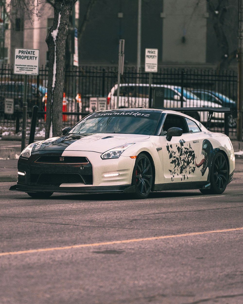 a white sports car driving down a street